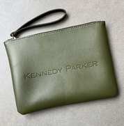 Green clutch bag with 'Kennedy Parker' branding on a light gray background